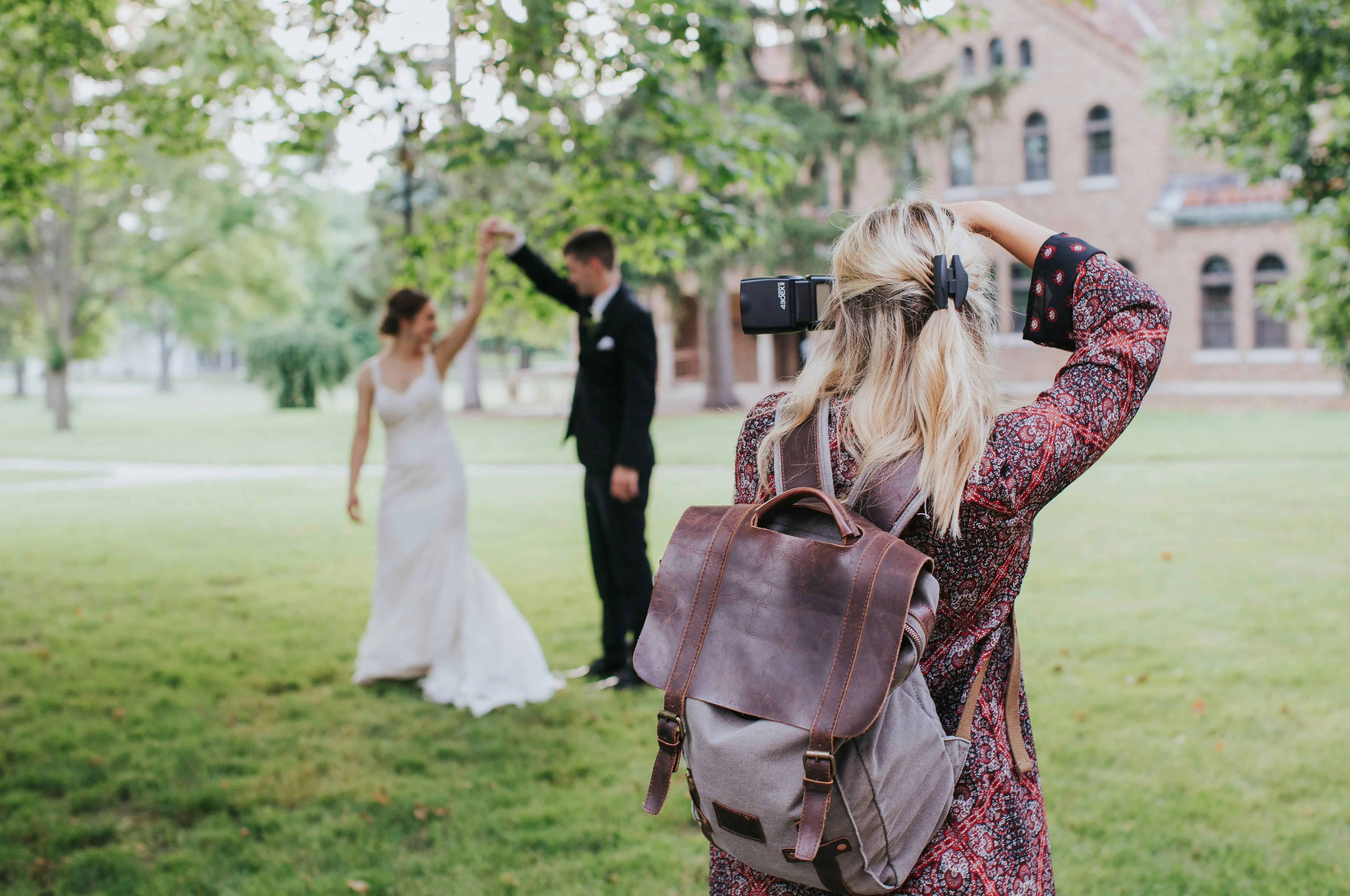 A wedding photographer at work, photographing the couple.